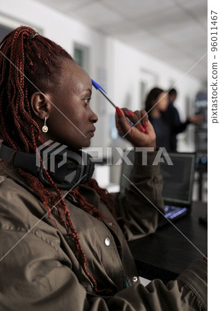 Pensive african american developer brainstorming ideas while typing code and create new interface in data room. Engineer programming server database in busy artificial intelligence developing agency. Pensive african american developer brainstorming ideas while typing code and create new interface in data room. Engineer programming server database in busy artificial intelligence developing agency. 96011467