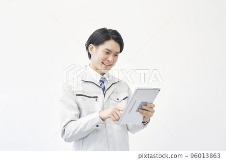 Workers using tablets white background Workers using tablets white background 96013863