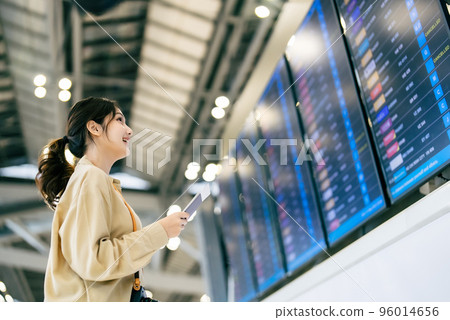 Young asian woman with passport and boarding pass as a hand in international airport Young asian woman with passport and boarding pass as a hand in international airport 96014656