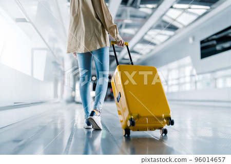 International airport terminal. Asian beautiful woman with luggage and walking in airport 96014657