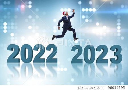 Businessman jumping from the year 2022 to 2023 Businessman jumping from the year 2022 to 2023 96014695