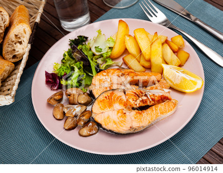 Deliciously steak of salmon with mushrooms and potatoes Deliciously steak of salmon with mushrooms and potatoes 96014914