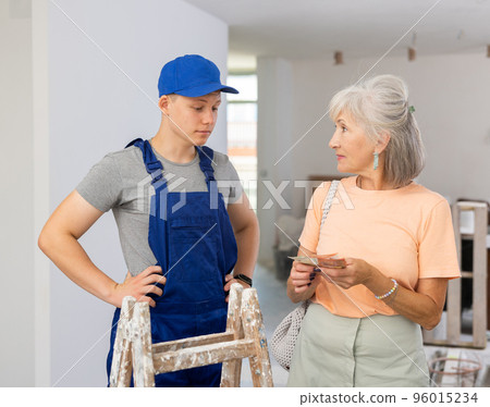 Teenager house painter getting paid for work 96015234