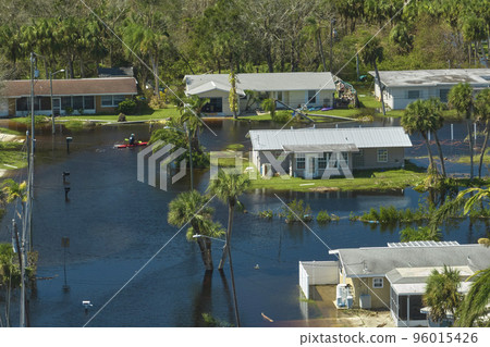 Surrounded by hurricane Ian rainfall flood waters homes in Florida residential area. Consequences of natural disaster 96015426