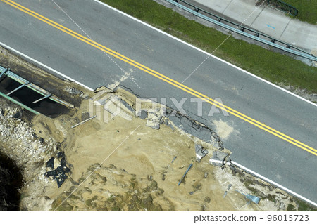Aerial view of damaged road after flood water washed away asphalt. Rebuilding of ruined transportation infrastructure 96015723