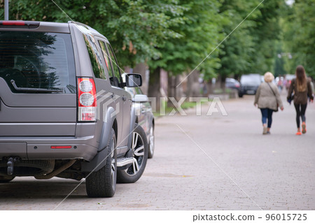 Cars parked in line on city street side. Urban traffic concept Cars parked in line on city street side. Urban traffic concept 96015725