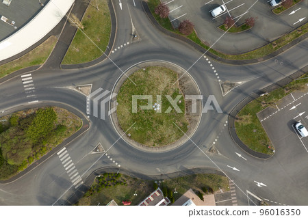 Aerial view of road roundabout intersection with fast moving heavy traffic. Urban circular transportation crossroads 96016350