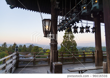 Dawn at the Nigatsu-do Hall of Todai-ji Temple, looking over the lanterns on the stage to see Ryoben-sugi and Mt. Ikoma Dawn at the Nigatsu-do Hall of Todai-ji Temple, looking over the lanterns on the stage to see Ryoben-sugi and Mt. Ikoma 96016508