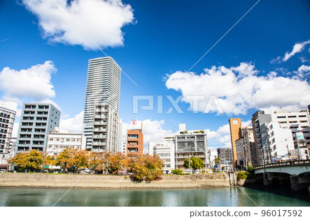 This is the view of the riverside city area to the east from the Enko Bridge near the south exit of Hiroshima Station. The building on the left is Grancross Tower Building 96017592