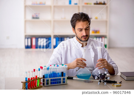 Young male chemist working at the lab Young male chemist working at the lab 96017846