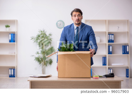 Young male employee in business relocation concept Young male employee in business relocation concept 96017903
