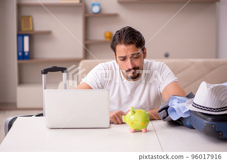 Young man preparing for trip at home Young man preparing for trip at home 96017916