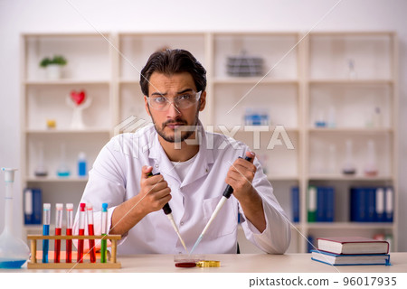 Young male chemist working at the lab Young male chemist working at the lab 96017935