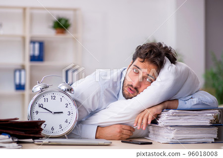 Young male employee in oversleeping concept 96018008