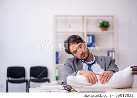 Young male employee in oversleeping concept 96018021