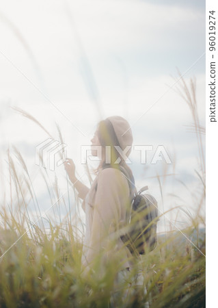 Photo of a woman holding a camera in nature Photo of a woman holding a camera in nature 96019274