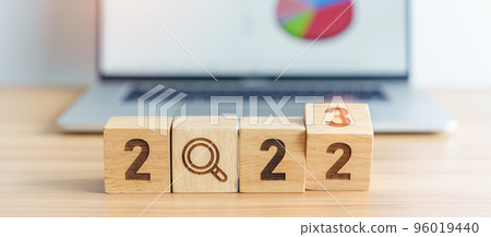 2023 block with magnifying glass icon against laptop background. Hiring, recruitment, job, jobless SEO, Search Engine Optimization and New Year concepts 96019440