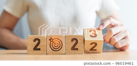 woman hand change 2022 to 2023 block with dartboard icon. Goal, Target, Resolution, strategy, plan, Action, mission, motivation, and New Year start concepts woman hand change 2022 to 2023 block with dartboard icon. Goal, Target, Resolution, strategy, plan, Action, mission, motivation, and New Year start concepts 96019461
