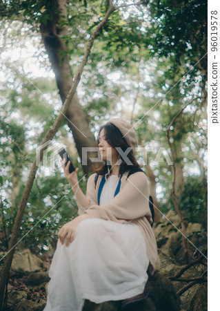 Photo of a woman listening to music in nature 96019578