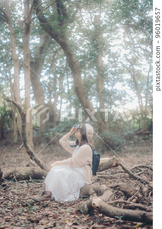 Photo of a woman doing creative activities while listening to music in nature Photo of a woman doing creative activities while listening to music in nature 96019657