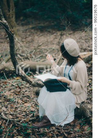 Photo of a woman doing creative activities while listening to music in nature Photo of a woman doing creative activities while listening to music in nature 96019676