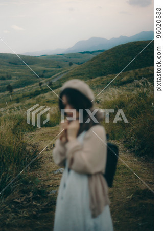 Photo of a woman hiking with a camera in nature Photo of a woman hiking with a camera in nature 96020888