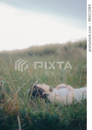 Photo of a woman standing in nature Photo of a woman standing in nature 96021064