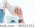 一個男人的手和一個處於高位的女人手牽手 96021151