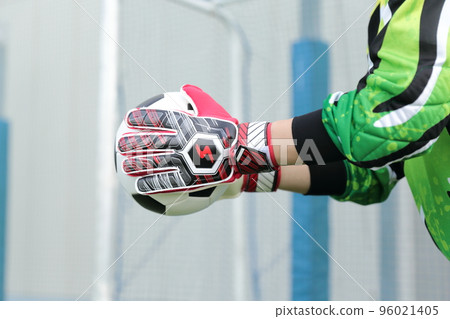 Goalkeeper man catching a soccer ball 96021405