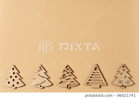 New Year's beige card, with a pattern of Christmas trees. Beige Christmas background for inscriptions. Clipart for a minimalistic Christmas card. Frame. Christmas trees top view. Winter holiday 96021741