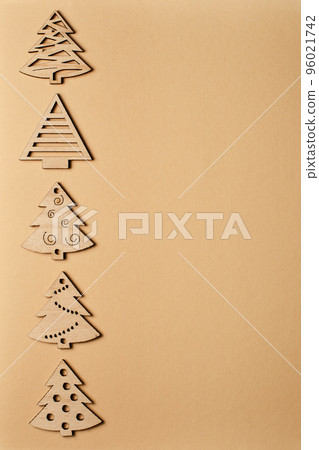 New Year's beige card, with a pattern of Christmas trees. Beige Christmas background for inscriptions. Clipart for a minimalistic Christmas card. Frame. Christmas trees top view. Winter holiday New Year's beige card, with a pattern of Christmas trees. Beige Christmas background for inscriptions. Clipart for a minimalistic Christmas card. Frame. Christmas trees top view. Winter holiday 96021742