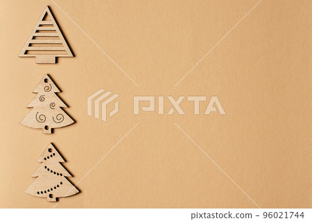 New Year's beige card, with a pattern of Christmas trees. Beige Christmas background for inscriptions. Clipart for a minimalistic Christmas card. Frame. Christmas trees top view. Winter holiday New Year's beige card, with a pattern of Christmas trees. Beige Christmas background for inscriptions. Clipart for a minimalistic Christmas card. Frame. Christmas trees top view. Winter holiday 96021744