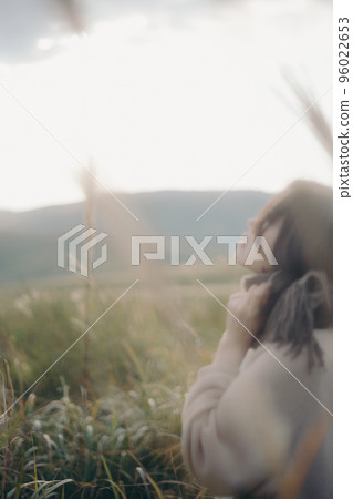 Photo of a woman listening to music in nature Photo of a woman listening to music in nature 96022653