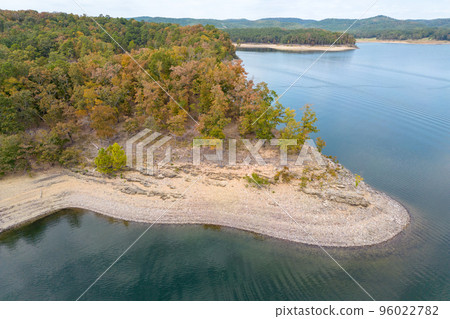 Aerial view of landscape of the surface of the water of Broken Bow lake, Oklahoma, USA. Autumn scenery of coastal line with forest on the bank. 96022782