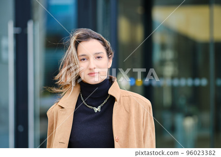 Young woman in front of bank building Young woman in front of bank building 96023382
