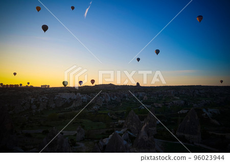 Sunrise panoramic view to Goreme city and flying balloons, Cappadocia, Turkey Sunrise panoramic view to Goreme city and flying balloons, Cappadocia, Turkey 96023944