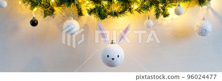 banner of Handmade christmas ball with ears in form of bunny hanging on the christmas tree. banner of Handmade christmas ball with ears in form of bunny hanging on the christmas tree. 96024477