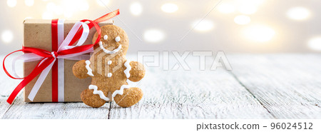 banner of Gingerbread man with box of gift on bokeh lights background 96024512