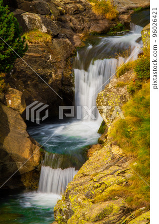 Nice mountain creek waterfalls in a Spanish Pyrenees mountain, near Vall de Nuria valley Nice mountain creek waterfalls in a Spanish Pyrenees mountain, near Vall de Nuria valley 96026421