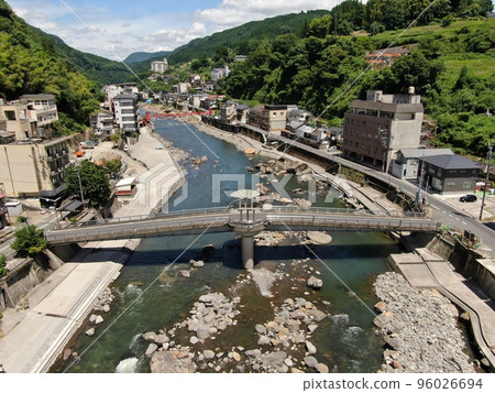Aerial view of the Amanose hot spring town where restoration of the Kusu River from flood damage is urgent 96026694