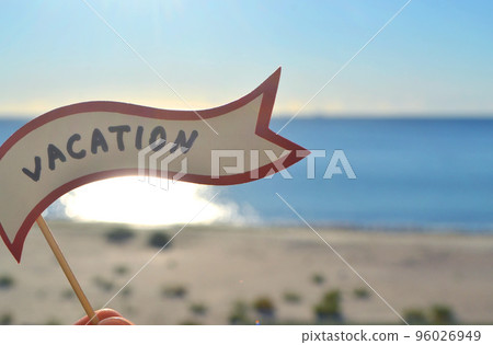Stick with paper speech bubble with words Vacation on background sea, sky, sandy beach on a sunny summer day. Text-balloons with text from letters. Concept, symbol, sign vacation travel tourism rest. Stick with paper speech bubble with words Vacation on background sea, sky, sandy beach on a sunny summer day. Text-balloons with text from letters. Concept, symbol, sign vacation travel tourism rest. 96026949