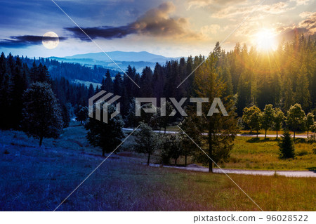 carpathian mountain landscape at summer twilight. day and night time change concept. beautiful countryside with forested hills and road through the valley with sun and moon 96028522