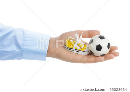 Hand with sport shoe and soccer football ball Hand with sport shoe and soccer football ball 96028684