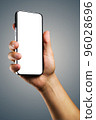 Smartphone with a screen template in the man's hand. 96028696