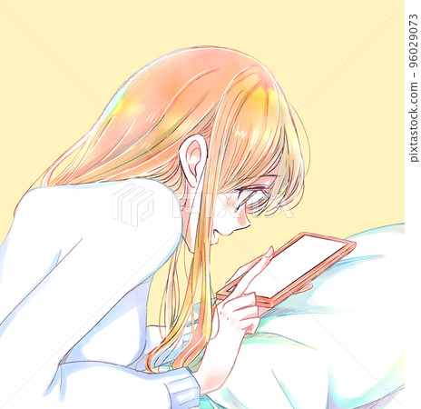 A woman lying face down happily touching her smartphone Winter pillow A woman lying face down happily touching her smartphone Winter pillow 96029073