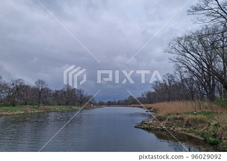 View of the river on a cloudy autumn day. The background of nature. View of the river on a cloudy autumn day. The background of nature. 96029092