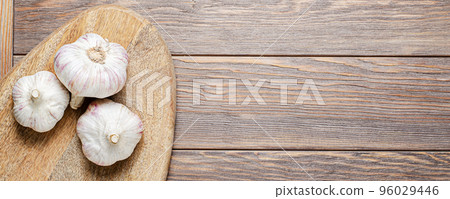 Garlic bulbs on a wooden chopping board. Copy space. Garlic bulbs on a wooden chopping board. Copy space. 96029446