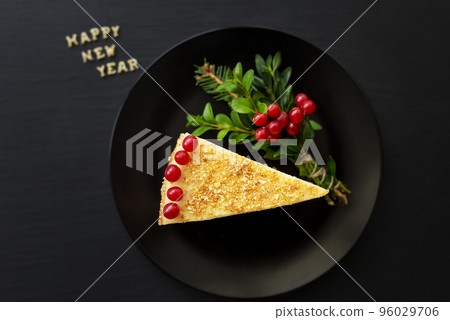 piece of cake decorated with the inscription happy new year 96029706