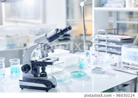 Workplace of virologist or other scientist with microscope and glassware necessary for new investigations and scientific experiments 96030114