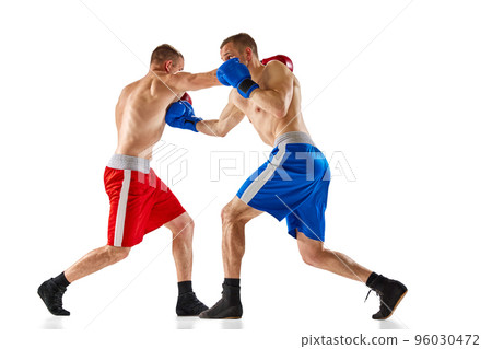Fight. Dynamic portrait of two professional boxer in sports uniform boxing isolated on white background. Concept of sport, competition, training, energy. Fight. Dynamic portrait of two professional boxer in sports uniform boxing isolated on white background. Concept of sport, competition, training, energy. 96030472